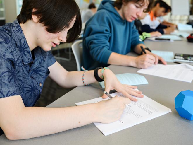 Students writing a CEMC mathematics contest in a classroom